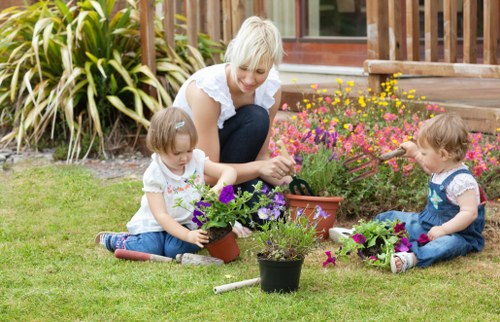 Garden maintenance team working on borders and lawn in Mottingham