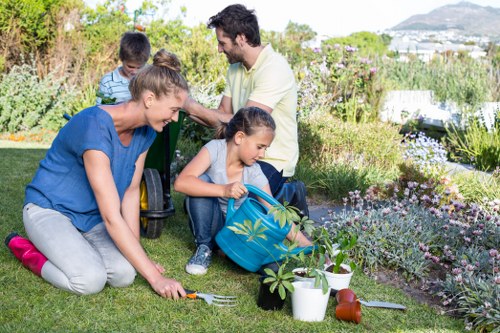 Front view of a well-maintained garden service team arriving with tools